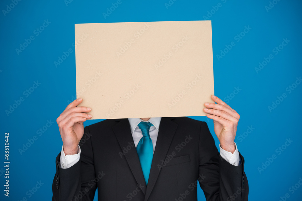 Businessman holding blank poster Businessman holding blank poster