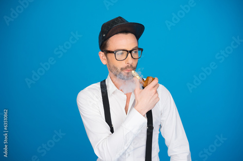 man wearing shirt and hat smoking e-pipe