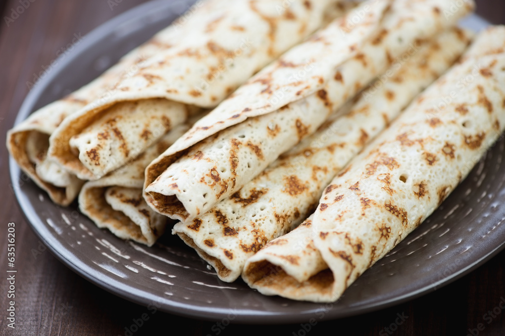 Close-up of rolled stuffed crepes, horizontal shot Close-up of rolled stuffed crepes, horizontal shot