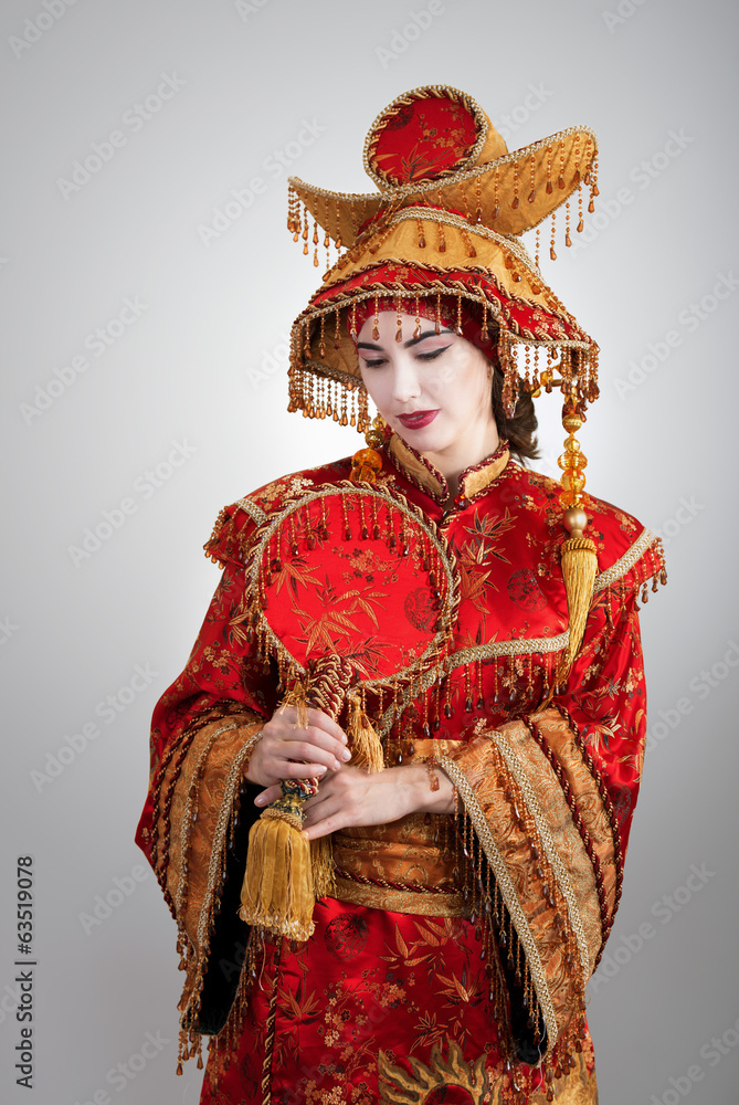 Woman in Chinese princess costume with a fan Woman in Chinese princess costume with a fan