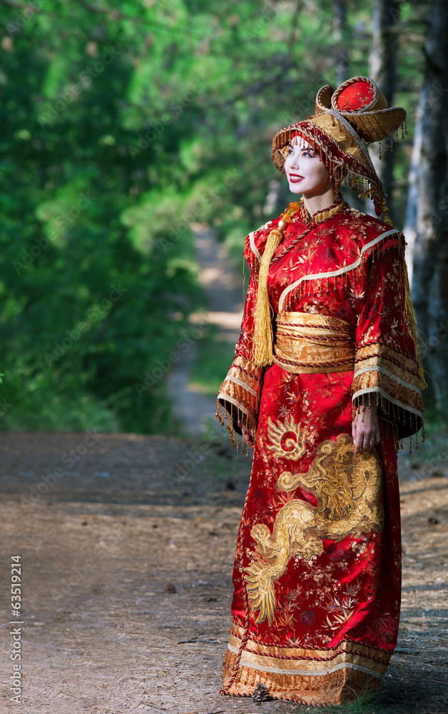 Woman in Chinese princess costume in the pine forest
