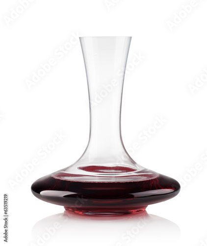 Red wine on a decanter isolated over white background photo