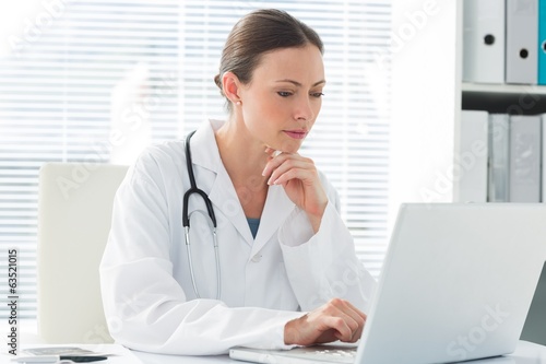 Female doctor using laptop