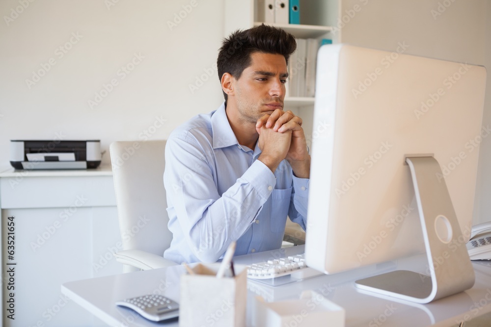 Casual businessman sitting at his desk Casual businessman sitting at his desk