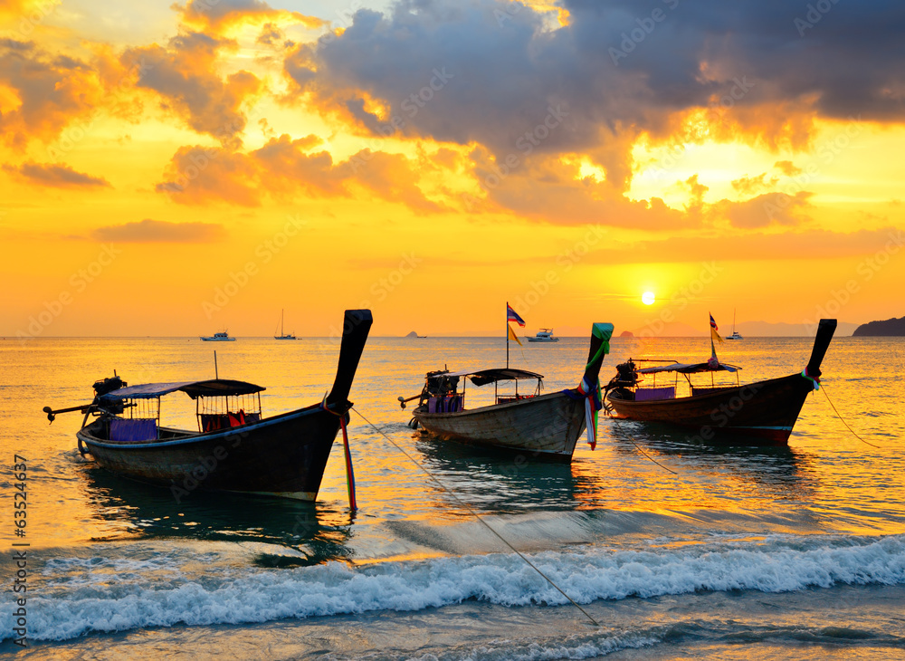Traditional thai boats at sunset beach