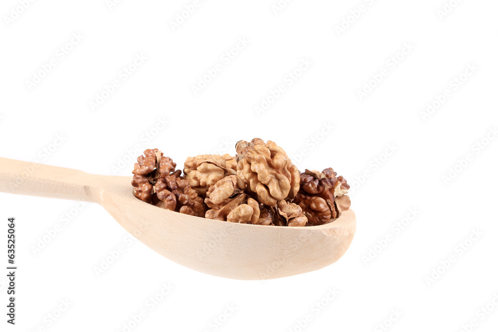 Wooden spoon full with walnuts
