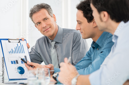 Businessmen Discussing Graph photo