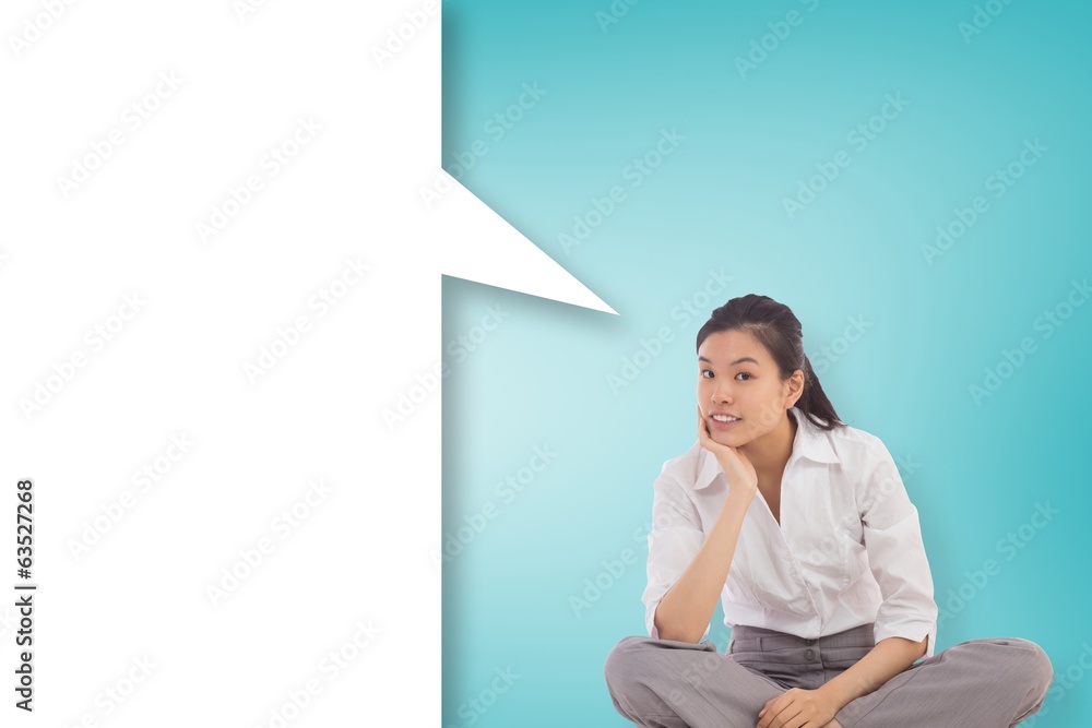 Composite image of businesswoman sitting cross legged thinking w