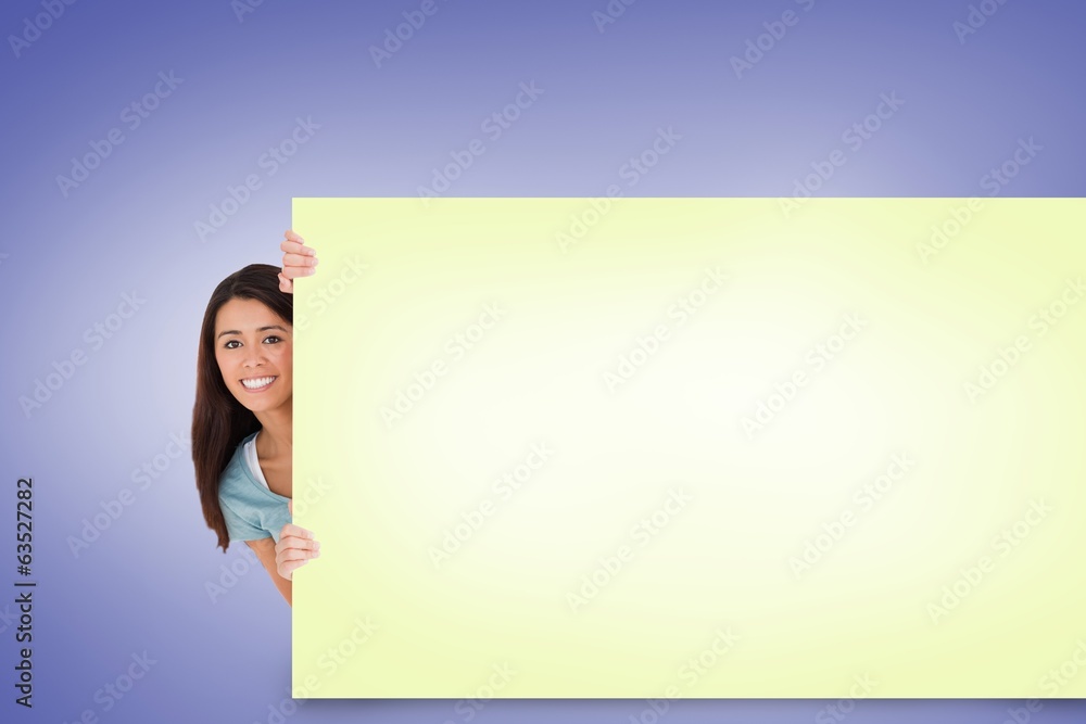 Composite image of pretty brunette showing card Composite image of pretty brunette showing card