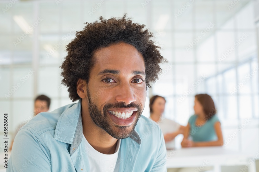Smiling businessman with colleagues in meeting Smiling businessman with colleagues in meeting