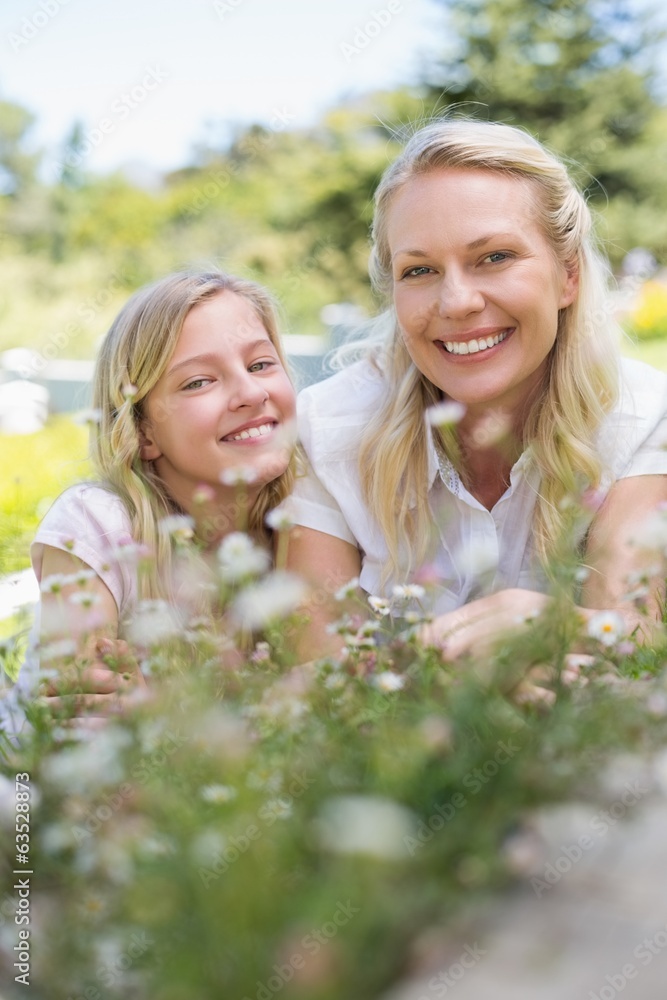Mother and daughter smiling in park Mother and daughter smiling in park