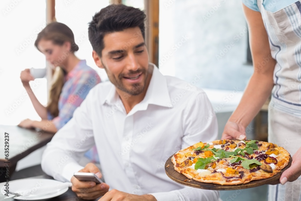 Waitress giving pizza to man at coffee shop Waitress giving pizza to man at coffee shop