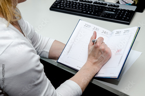 hand with pen and diary