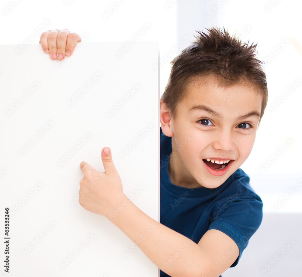 Cute boy is holding blank banner Cute boy is holding blank banner