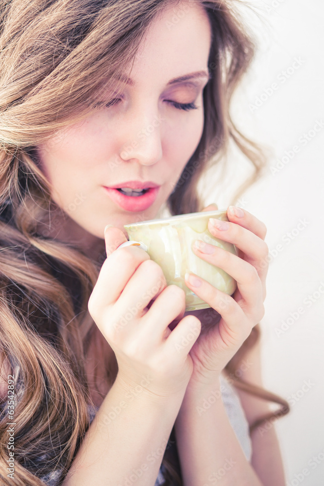 The girl in a white jacket holding the Cup in the Studio. The girl in a white jacket holding the Cup in the Studio.