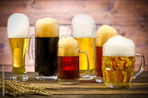 Variety of beer glasses on a wooden table