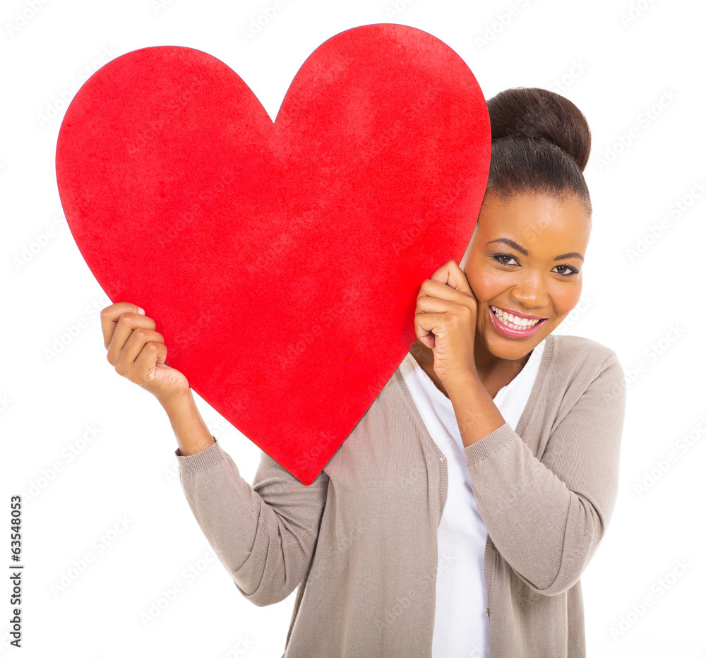 happy african woman holding red heart symbol