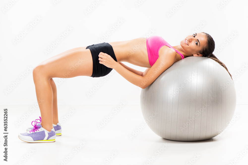Naklejka premium Exercising and lifting the weights with Exercise Ball