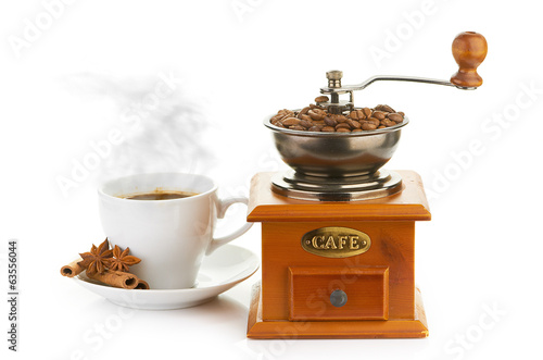 Manual coffee grinder with beans and cup