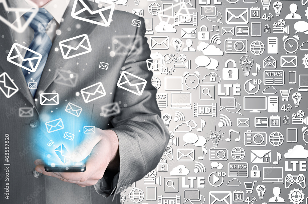 Business man holding smart phone and sending emails Business man holding smart phone and sending emails