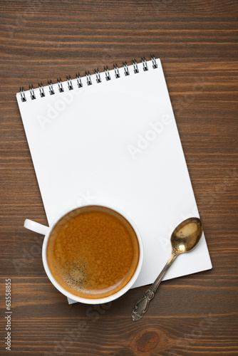cup of coffee, spoon and note pad, concept photo