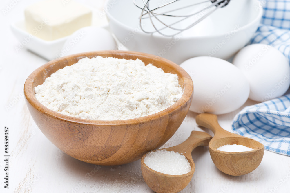 flour, salt, sugar and eggs for baking pancakes on wooden table flour, salt, sugar and eggs for baking pancakes on wooden table