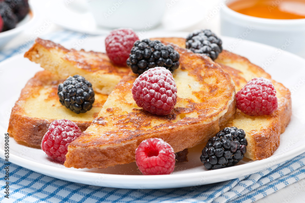 French toast with fresh berries and powdered sugar, close-up French toast with fresh berries and powdered sugar, close-up