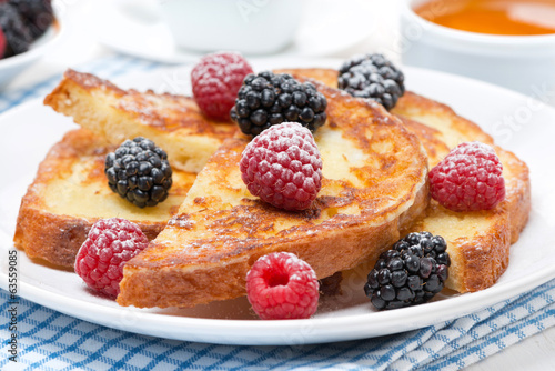 French toast with fresh berries and powdered sugar, close-up