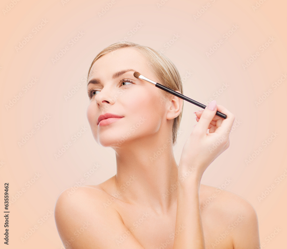beautiful woman with makeup brush beautiful woman with makeup brush