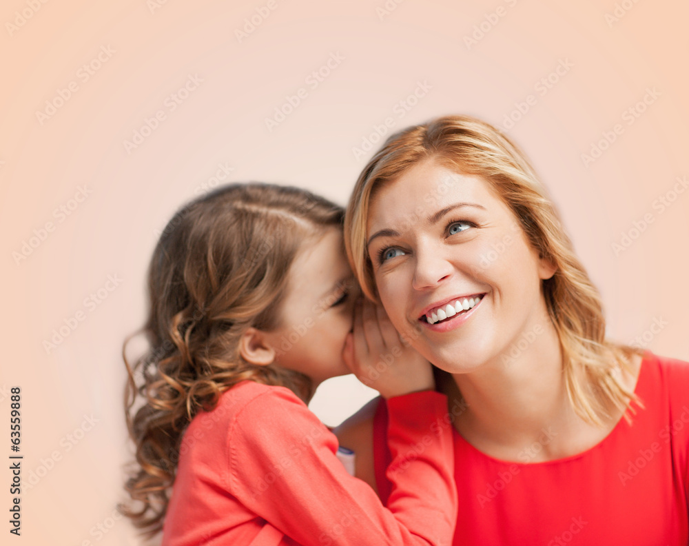 smiling mother and daughter whispering gossip smiling mother and daughter whispering gossip