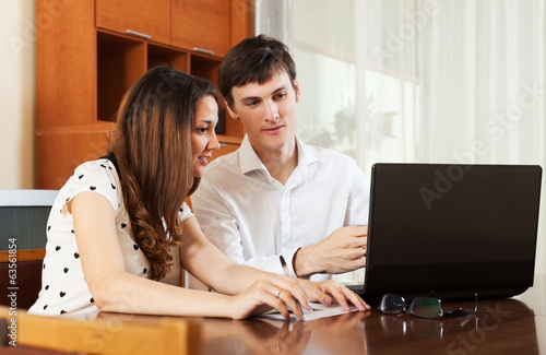 Couple with laptop at home