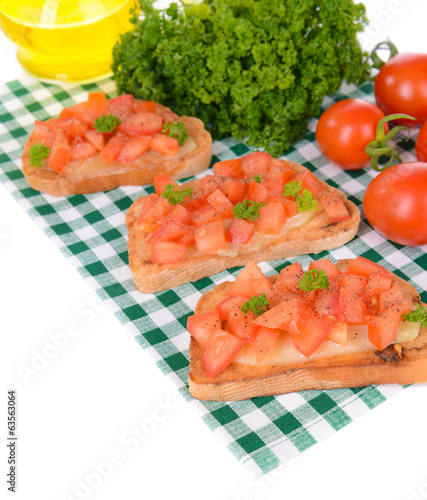 Delicious bruschetta with tomatoes on table close-up