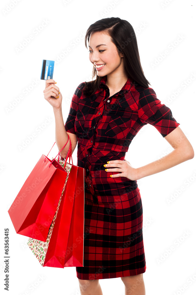 Woman posing with shopping bags and debit card Woman posing with shopping bags and debit card
