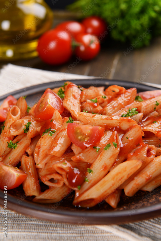 Pasta with tomato sauce on plate on table close-up Pasta with tomato sauce on plate on table close-up