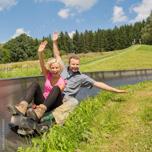 Couple Enjoying Summer Sledge