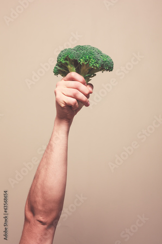 Holding broccoli in the air