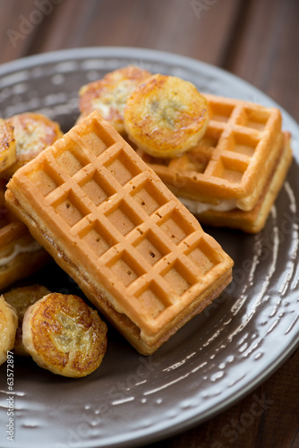 Close-up of waffles with fried banana, vertical shot