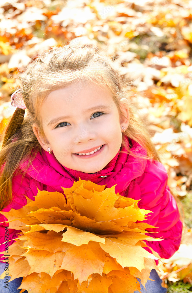 Autumn portrait of cute smiling little girl with maple leaves Autumn portrait of cute smiling little girl with maple leaves
