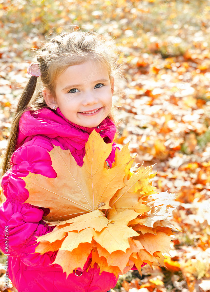 Autumn portrait of cute smiling little girl with maple leaves Autumn portrait of cute smiling little girl with maple leaves
