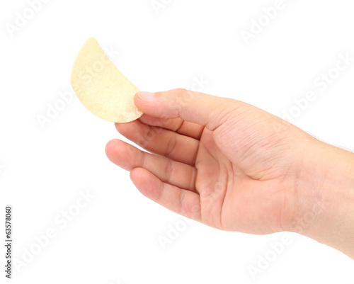 Hand holds potato chips.