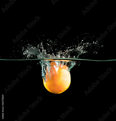 Orange in water over black