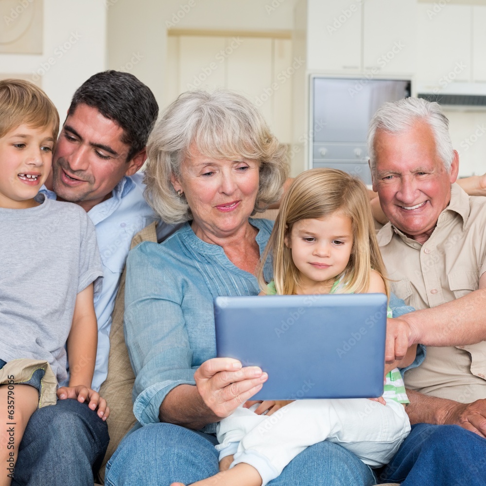 Smiling family using digital tablet Smiling family using digital tablet