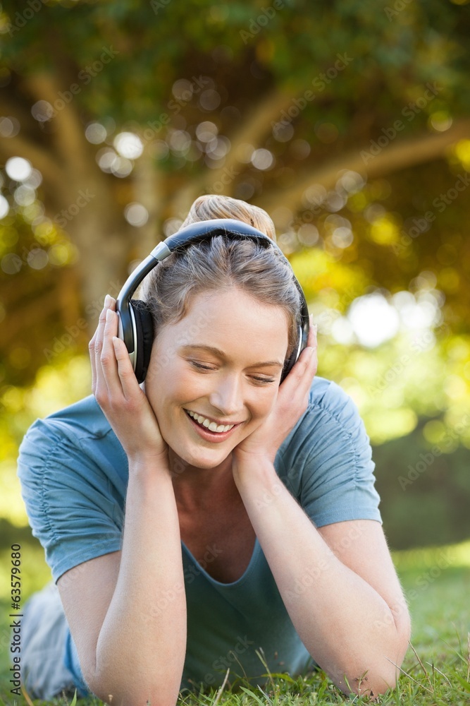 Beautiful relaxed woman enjoying music in park Beautiful relaxed woman enjoying music in park