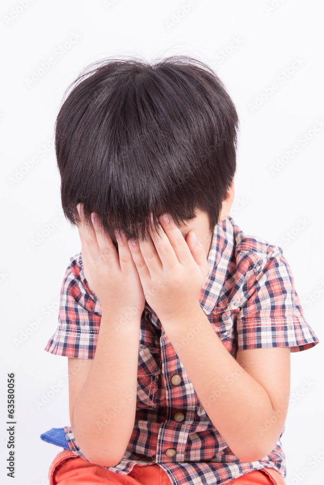 Young little boy crying or playing with hiding face Young little boy crying or playing with hiding face