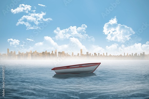 Small boat in the sea with city on horizon © WavebreakmediaMicro