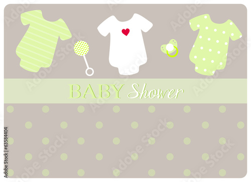 three baby bodysuits, a pacifier and a little rattle