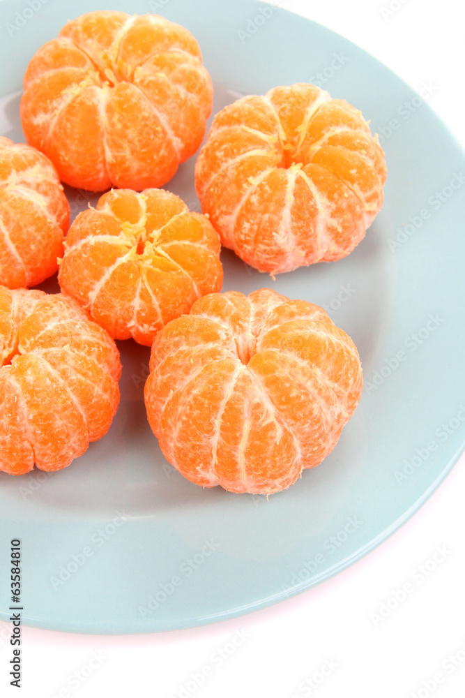 Ripe sweet tangerines on color plate, isolated on white Ripe sweet tangerines on color plate, isolated on white