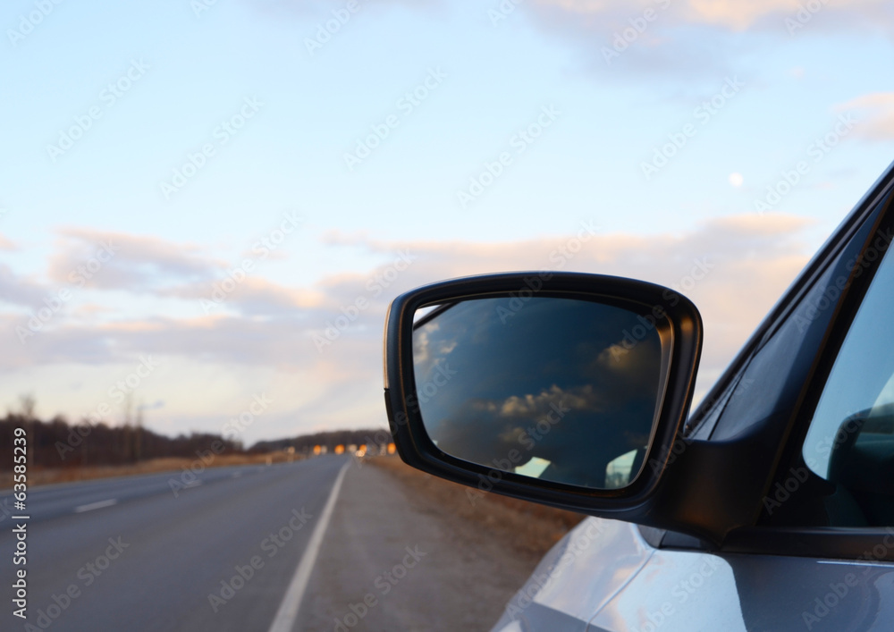 reflection seen through car side mirror - sunset