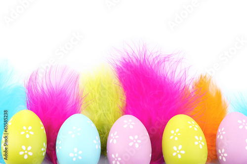 Easter eggs and decorative feathers, isolated on white
