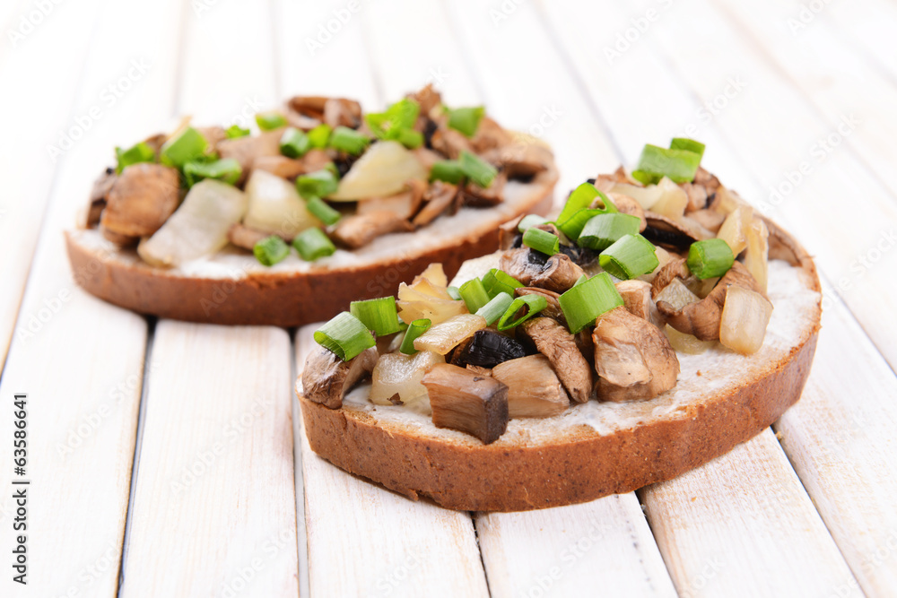 Delicious bruschetta with mushrooms on table close-up Delicious bruschetta with mushrooms on table close-up